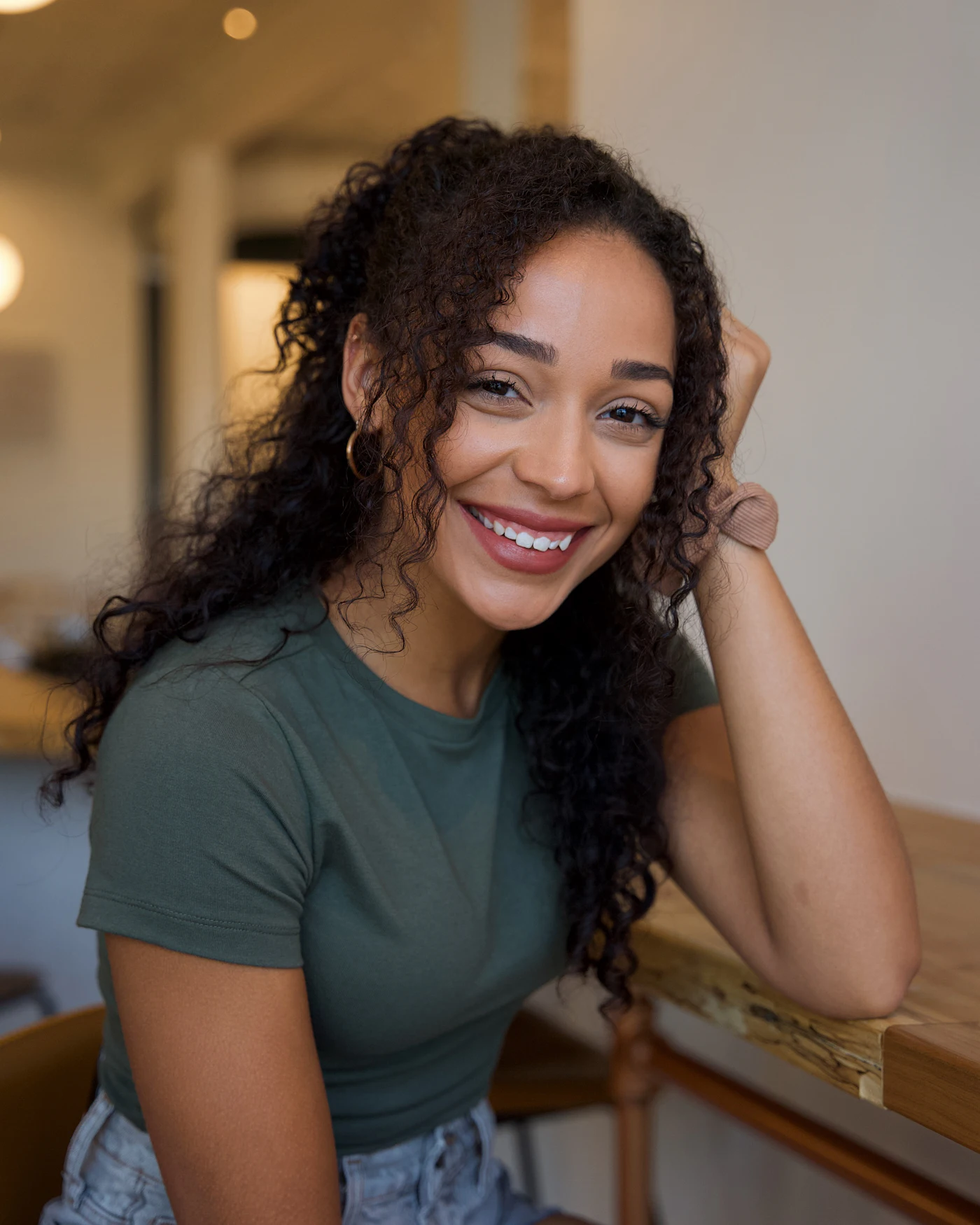 Amara smiling at a table at home