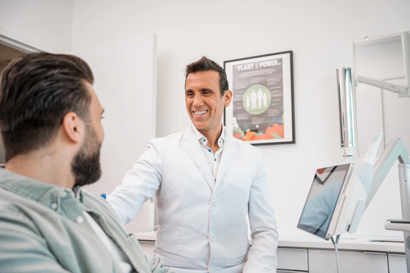 Dr Owen Price laughing with a patient in the chair