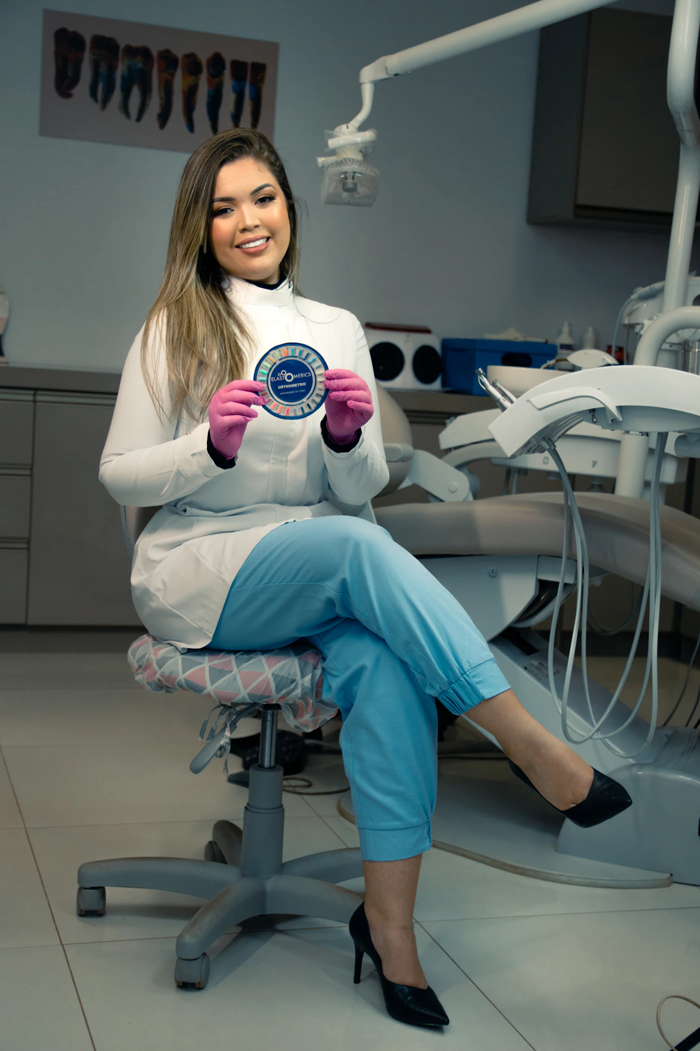 Sofia Reyes sitting in the surgery holding a model of teeth